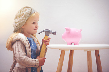 Image showing Naughty, looking and a child with a hammer and piggy bank for savings, money and coins. Finance, idea and a little girl thinking of breaking a box for cash, wealth and financial growth with tools
