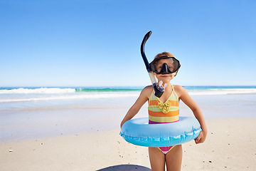 Image showing Beach, fun and girl child with swimming inflatable, snorkel and excited against ocean background. Adventure, portrait and kid at the sea with a swim ring for exploring, playing and vacation in Bali