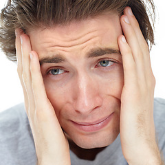 Image showing Man, depressed thinking and hands in studio with fear, mental health problem or frustrated by white background. Male model, sad student and anxiety, scared and crying with stress on mind