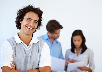 Image showing Portrait, smile and business man with arms crossed in office confident, empowered and excited. Happy, face and proud male entrepreneur in meeting with team for management, leadership and mission