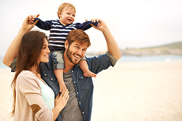 Image showing Love and baby with parents at a beach for piggyback, fun and walking in nature. Family, kid and happy woman with man outdoors bonding, smile and relax while enjoying travel, freedom or game