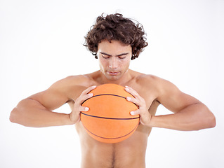 Image showing Sports, squeeze and man with basketball in studio isolated on a white background. Sport, fitness and athlete holding ball, eyes closed and ready for training, exercise or workout for wellness.