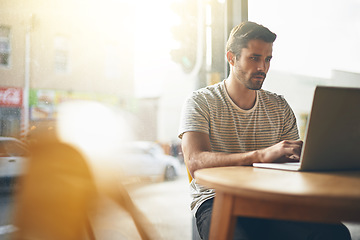 Image showing Coffee shop, working and man with laptop and lens flare doing code remote work in a cafe. Tech, email and male freelancer customer at a restaurant and computer writing with focus on web coding