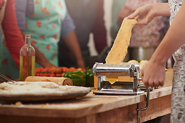 Image showing Food, fresh pasta with hands of woman at kitchen counter and with people in family restaurant. Cooking or bakery, rolling pin and female person with pastry machine preparing pizza or cooking dough