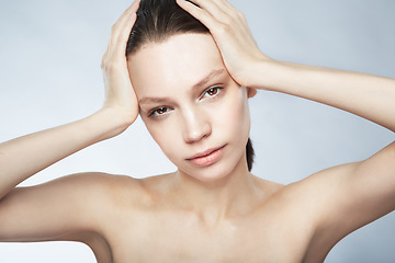 Image showing Glow, face portrait and a woman with beauty from skincare isolated on a white background in a studio. Serious, young and a female model for dermatology and cosmetics on a backdrop for care of skin