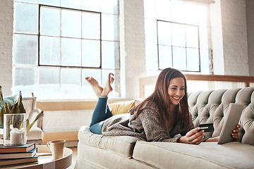 Image showing Relax, tablet and credit card, happy woman on sofa in living room and internet banking or fintech in home. Technology, online shopping payment and girl on couch surfing retail website or digital shop