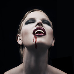 Image showing Blood, woman and vampire with fantasy, fangs and lady against a dark studio background. Female person, supernatural being and girl mystic, aesthetic and monster with creativity, demon and character