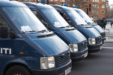 Image showing Street, city and row of police vans for a public service and safety during a protest or march. Security, crime and law enforcement transport in a line as a barrier in urban town strike for protection