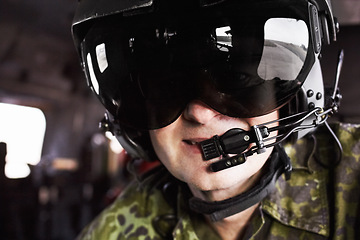 Image showing Military, pilot and mature man in a helicopter with microphone for communication, location and navigation. Army, airplane and face of male professional aircraft flyer with gear and flight helmet