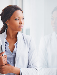 Image showing Thinking, window and future with a business black woman standing in her office for reflection of the company vision. Idea, mission and mindset with a young employee at work to contemplate a thought