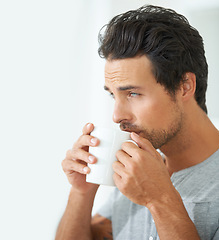 Image showing Wake up, morning and a man drinking coffee from a mug in his home alone on the weekend to relax. Face, thinking and caffeine with a handsome young male model enjoying a fresh beverage in his house