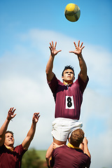 Image showing Sports, rugby player catch and with ball on field of grass. Teamwork or collaboration, professional athlete and strong athletic men or fitness people together as a team in sportswear or gear