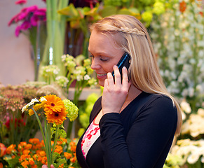 Image showing Woman florist in shop with flowers, phone call and communication with small business contact. Female owner, customer and talking to flower supplier on mobile, botany industry or nursery on technology