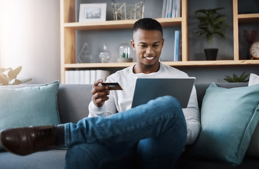 Image showing Ecommerce, black man bank card and laptop in living room on sofa at his home. Online shopping, technology and happy African male person on couch with internet banking with digital device at house