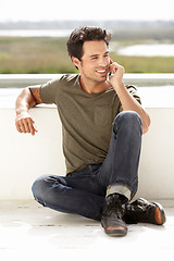 Image showing Smile, phone call and man with connection, outdoor and relax with communication. Male person, network and guy with a smartphone, talking and mobile app with casual outfit, trendy clothes and talking