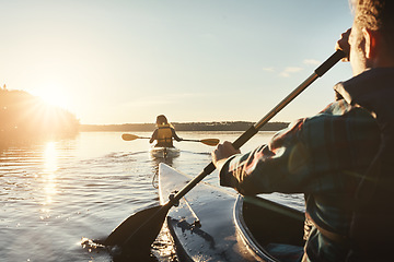 Image showing Kayak, lake and people rowing a boat on the water during summer for recreation or leisure at sunset. Nature, view and horizon with people canoeing for adventure, freedom or travel while on vacation