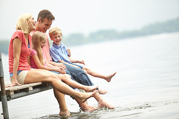 Image showing Family, holiday and water with mockup and foot at lake during the summer for travel with love. Child, parent and adventure at river on deck with freedom to relax with space and time for lifestyle.