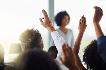 Image showing Back, business people and hands raised for questions at conference, seminar or meeting. Group, audience and hand up for question, asking or answer, crowd vote and training at workshop presentation.