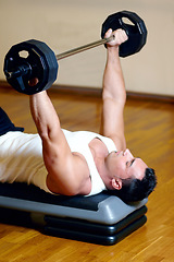 Image showing Barbell, bench press and man doing gym workout, fitness circuit or training for bodybuilding, muscle growth, sports challenge. Wellness, strong and person working on weightlifting floor exercise