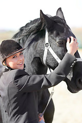 Image showing Horse rider, trainer portrait and woman on equestrian training and competition ground. Outdoor, female competitor and show horses stable with a girl smile stroking an animal before riding with helmet