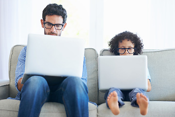 Image showing Father, child and laptop working on sofa in living room together with technology and glasses at home. Dad, kid or little boy pretend to work in remote work on lounge couch with computer indoors