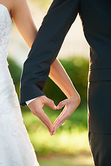 Image showing Hands, bride and groom heart sign at wedding, celebration or vow ceremony and love, couple and marriage. Man, wife and commitment together and care, unity and promise for relationship happiness