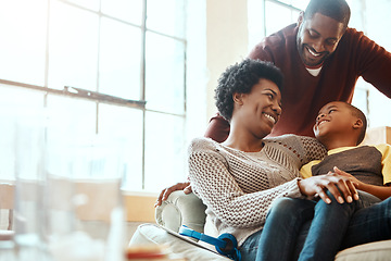 Image showing Happy, love and family bonding on a sofa together in the living room of their modern house. Happiness, smile and African parents spending quality time, talking and relaxing with her boy child at home