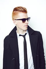 Image showing Fashion, cool and man in a suit in a studio with sunglasses and a stylish formal outfit. Young, cool and handsome male model with elegant trendy style and confidence isolated by a white background.