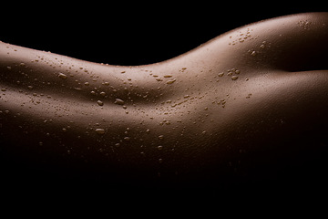 Image showing Water drops, back and dark studio person with sexy seductive body, creative sensual shadow or erotic sexual art. Sweat, naked wet skin or closeup silhouette of nude model isolated on black background