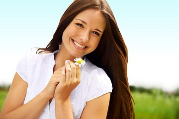 Image showing Portrait, smile and woman with daisy outdoor, on holiday and enjoying spring on vacation in countryside. Face, flower plant and beauty of female person relaxing, smiling and having fun in nature.