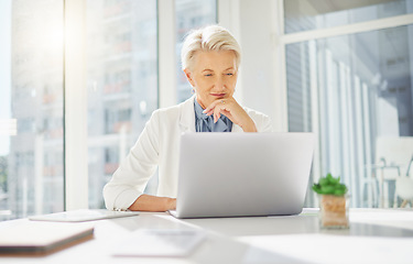 Image showing Laptop, thinking and senior business woman in office inspired by research, idea and mission plan. Online, project and happy elderly female manager inspired while typing, browsing or planning proposal