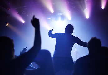 Image showing Rock concert, dance and party crowd with disco lighting and people back with dancing. Silhouette, audience and night festival event with performance and group listening and watching a band music