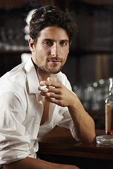 Image showing Portrait, young man and smoking at a bar or cigarette at hand or handsome guy relaxing and unbuttoned shirt. Sexy, masculine and attractive model with ash tray or about to have a drink after work