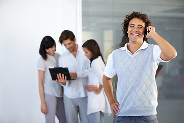 Image showing Phone call, office and happy business man with team in conversation, discussion and networking. Communication, corporate and male worker on cellphone talking, speaking and connection in workplace