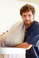 Image showing Brewery, portrait and man with a bag for beer production or manufacturing in a industrial factory. Proud, industry and male brewer or worker brewing lager with ingredients in a alcohol distillery.