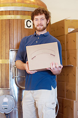 Image showing Box, brewer and portrait of man with beer case after manufacturing product in a factory or distillery. Industry, happy and young male person, worker or seller smile and proud of alcohol product