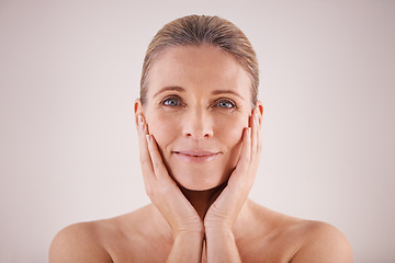 Image showing Portrait, senior woman and face for cosmetic wellness or touching her perfect skin or isolated and on grey background. Mature lady, massaging wrinkles and facial aging or dermatology and skincare