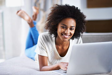 Image showing Smile, relax and woman with a laptop, typing and connection for movies, social media and online reading. Female person, happy lady and girl with happiness, technology and chatting at home