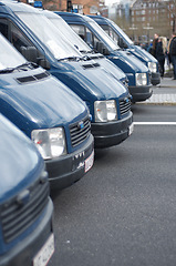 Image showing Security, police and row of vans in the city for a public service during a protest or march. Safety, crime and law enforcement transport in a line as a barrier in an urban town strike for protection.