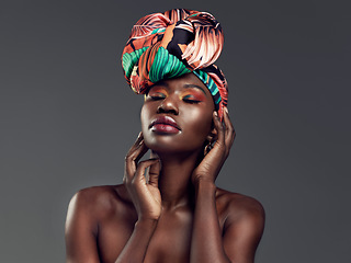 Image showing Beauty, makeup and black woman with a turban in studio with a elegant, glam and cosmetic face. Beautiful, young and African female model with a head wrap with sensual pose isolated by gray background