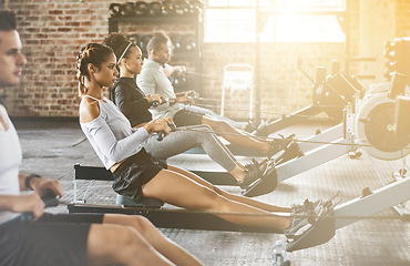 Image showing Rowing machine, group and training in gym, class or fitness workout, exercise or cardio, row team and practice. People, healthy athlete and challenge on sport equipment, row crew and sports club