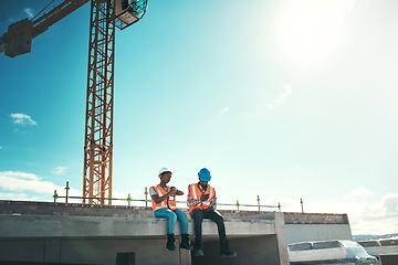 Image showing Engineer, team and talking on building roof at construction site about break time, development or architecture. Black woman and man outdoor for engineering project, teamwork or safety with sky mockup