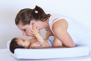 Image showing Mother, smile and baby kiss at home on diaper changing table with happiness. Family, house and young child with mom feeling love, care and parent support from bonding together with cute kid and mama