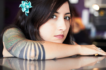 Image showing Beauty, tattoo and portrait of woman in parlor for body art, design and creativity in ink shop. Face, artist and serious female person with flower in hair with cosmetics, natural beauty and tattoos