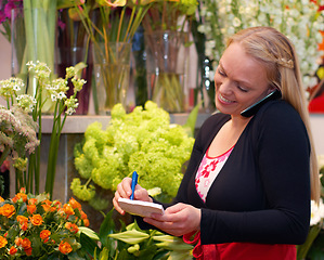 Image showing Small business, woman on phone call and in florist writing an order. Flowers or plants, communication or customer service and female worker with smartphone or cellphone with client for a bouquet