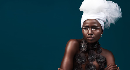 Image showing Art, fashion and a thinking black woman for culture isolated on a dark background in a studio. Mockup, idea and an African person wearing traditional headwear with cosmetics for cultural confidence
