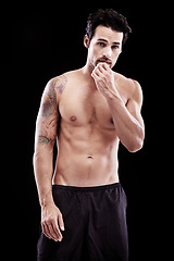 Image showing Portrait of strong man, fitness and abs on black background, studio and sexy six pack. Muscular bodybuilder, male model and topless sports athlete with tattoo, muscle and power for exercise training