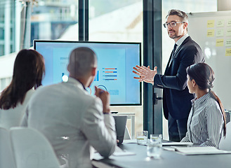 Image showing Business man, presentation and graph screen in office for training, meeting or workshop. Men and women at table to listen to speaker, coach or manager talking about strategy, sales growth or pitch
