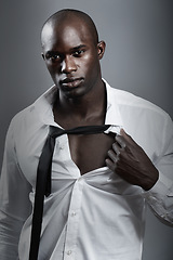 Image showing Portrait, sexy and black man with muscle, body and wellness against a dark studio background. Face, male person and model with confidence, attractive and handsome with sensual look and muscular guy