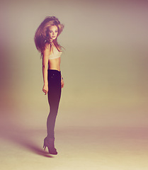 Image showing Fashion, jump and woman portrait in heels with style and freedom in a studio. Isolated, brown background and jumping of young female person with beauty and body confidence with youth and carefree